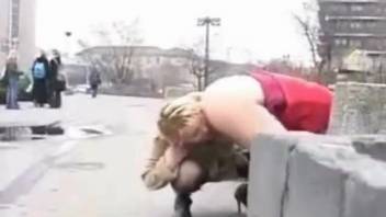 Female urinates into her pal's mouth on the public road
