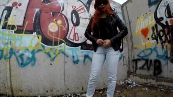 Ginger-haired chick in shades taking a dump on the road
