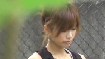Petite Asian female defecating on the public road